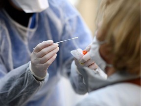 A doctor has samples taken at a COVID-19 screening centre reserved for health professionals on March 27, 2020 in Paris, as the country is under lockdown to stop the spread of the Covid-19 pandemic caused by the novel coronavirus.