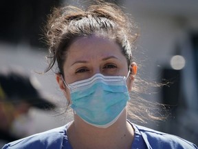 A member of the medical staff listens as Montefiore Medical Center nurses call for N95 masks and other critical PPE to handle the coronavirus (COVID-19) pandemic on April 1, 2020 in New York.