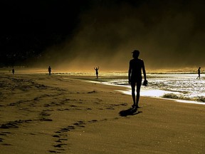 People keep social distancing as they enjoy Copacabana beach, in Rio de Janeiro, Brazil during the COVID-9 coronavirus pandemic on April 13, 2020 early morning.