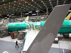 In this file photo taken on March 27, 2019, employees work on Boeing 737 MAX airplanes at the Boeing Renton Factory in Renton, Washington.