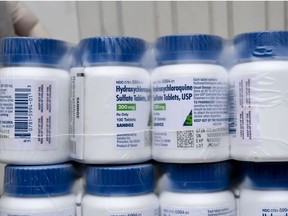 A Salvadoran Health Ministry worker shows a package of bottles of HydroxyChloroquine pills to be distributed in hospitals in San Salvador on April 21, 2020, amid the COVID-19 coronavirus outbreak.