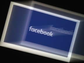 In this file photo illustration, a Facebook App logo is displayed on a smartphone in Arlington,