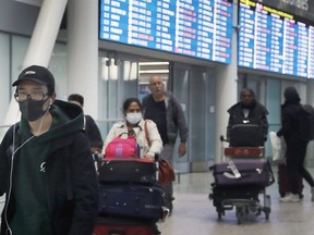 Passengers arrive at Pearson International Airport on Wednesday, March 4, 2020.