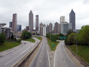 A lone car is seen on the highway leading to the city of Atlanta during the novel coronavirus pandemic in Atlanta, Georgia on April 23, 2020.