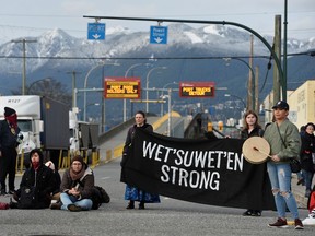 Supporters of the indigenous Wet'suwet'en Nation's hereditary chiefs block the entrance to the Port of Vancouver at Hastings street and Clark Drive, as part of protests against the Coastal GasLink pipeline, in Vancouver, Feb. 24, 2020.
