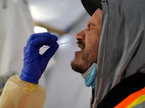 Provincial health workers perform coronavirus disease nasal swab tests on Raymond Robins of the remote First Nation community of Gull Bay, Ontario April 27, 2020.