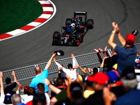 Fernando Alonso of Spain waves at the crowd on track during practice for the Canadian Grand Prix at Circuit Gilles Villeneuve on June 9, 2016 in Montreal. (Dan Istitene/Getty Images)