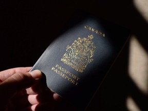 A Canadian passport is displayed in Ottawa on Thursday, July 23, 2015.