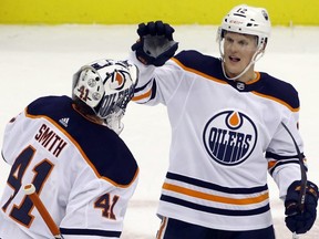 Oilers goaltender Mike Smith (41) and centre Colby Cave (12) celebrate after defeating the Pittsburgh Penguins at PPG PAINTS Arena. (Charles LeClaire-USA TODAY Sports)