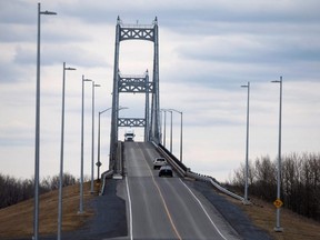 A truck drives over the Seaway International Bridge from the U.S. into Canada after movement restrictions came into effect due to COVID-19, on Cornwall Island, Ont., March 25, 2020.