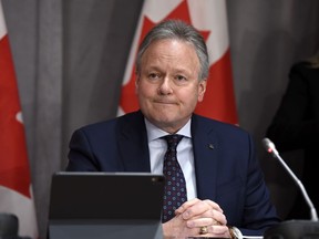 Governor of the Bank of Canada Stephen Poloz listens to a question at a press conference on Parliament Hill in Ottawa, on Wednesday, March 18, 2020.