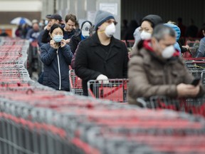 Hundreds of people wait in line to enter Costco in Toronto on Monday, April 13, 2020. Health officials and the government have asked that people stay inside to help curb the spread of COVID-19.
