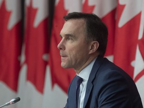 Minister of Finance Bill Morneau responds to a question during a news conference in Ottawa, Friday, March 27, 2020.  Parliament's spending watchdog says three federal measures to help low-income earners, families and seniors weather the economic shock from COVID-19 will cost over $8 billion.