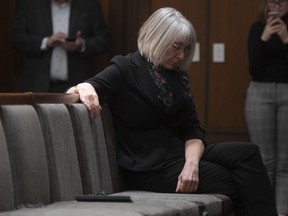 Minister of Health Patty Hajdu sits in the front row of seats instead of onstage to ensure spacing between speakers during a news conference in Ottawa, Monday, March 30, 2020.