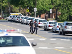 Police cars line the side of a street in Toronto in 2012.