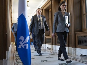 Quebec Health Minister Danielle McCann and Quebec Premier François Legault walk to their daily coronavirus press conference on March 31, 2020.