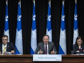 Quebec Premier Francois Legault during a news conference on the COVID-19 pandemic April 27, 2020. He was with Horacio Arruda, Quebec director of public health, left, and Quebec Health Minister Danielle McCann.