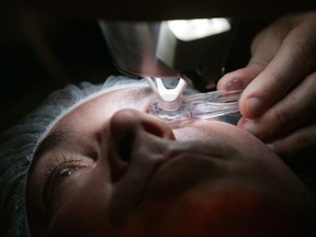 In this Nov. 1, 2005 file photo, a doctor prepares a patient for eye surgery in Chicago.