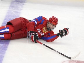 Team Russia's Mikhail Grigorenko is shown following a hit during hockey game action against Latvia at the 2012 IIHF World Junior Championships. in Calgary, Dec. 29, 2011.