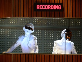 Grammy winners Daft Punk perform on stage for the 56th Grammy Awards at the Staples Center in Los Angeles, California, Jan. 26, 2014.