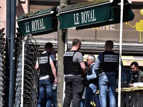French Police Judiciaire officers stand in a street in the centre of Romans-sur-Isere, on April 4, 2020, after a man attacked several people with a knife. (JEFF PACHOUD/AFP via Getty Images)