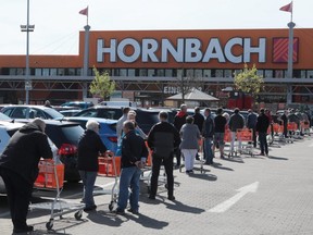 People queue to enter a hardware store as the spread of coronavirus continues in Berlin, Germany, April 16, 2020. (REUTERS/Reinhard Krause)
