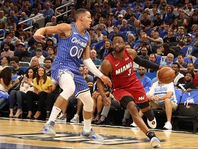 Dwyane Wade of the Miami Heat attempts to drive past Aaron Gordon of the Orlando Magic during the game at Amway Center on October 17, 2018 in Orlando, Florida.