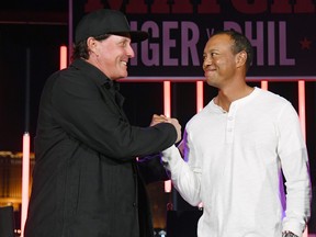 Phil Mickelson, left, and Tiger Woods greet each other at The Match: Tiger vs Phil VIP after party at Topgolf Las Vegas on Nov. 23, 2018 in Las Vegas, Nevada. (Ethan Miller/Getty Images for The Match)