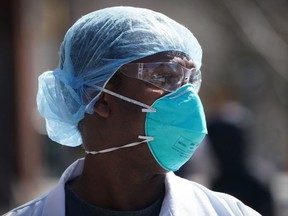 A member of the medical staff listens as Montefiore Medical Center nurses call for N95 masks and other critical PPE to handle the coronavirus (COVID-19) pandemic on April 1, 2020 in New York. - The nurses claim "hospital management is asking nurses to reuse disposable N95s after long shifts" in the Bronx. (Photo by Bryan R. Smith / AFP) (Photo by BRYAN R. SMITH/AFP via Getty Images)