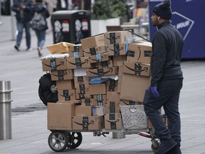 An Amazon delivery person walks in Times Square following the outbreak of Coronavirus disease (COVID-19), in the Manhattan borough of New York City, New York, U.S., March 17, 2020.