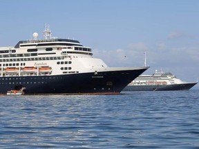 Passengers board a lifeboat from Holland America Line cruise ship MS Zaandam to be transported to her sister ship Rotterdam (R) on Panama Bay, Panama during a coronavirus disease (COVID-19) outbreak on March 28, 2020.
