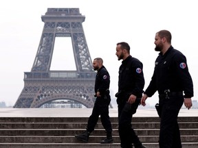 French police patrol at the Tocadero square near the Eiffel tower in Paris as a lockdown imposed to slow the rate of the coronavirus disease (COVID-19) contagion started at midday in France, France, March 17, 2020.