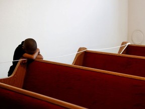 Zechariah Payton, 5, puts his head down on an empty pew, on the third day of California Governor Gavin Newsom's implemented statewide "stay at home order" directing the state's residents to stay in their homes in the face of the fast-spreading coronavirus disease (COVID-19), before a Facebook Live service at Rising Star Church in Oakland, California, U.S. March 22, 2020.