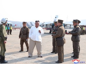 This undated picture released from North Korea's official Korean Central News Agency (KCNA) shows North Korean leader Kim Jong Un inspecting a pursuit assault plane group under the Air and Anti-Aircraft Division in the western area of North Korea.