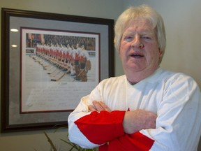 Pat Stapleton stans next to a photo of Team Canada at the 1972 Summit Series in 2010..