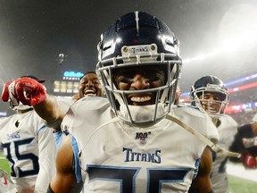 Logan Ryan  of the Tennessee Titans celebrates his touchdown with teammates against the New England Patriots in the fourth quarter of the AFC Wild Card Playoff game at Gillette Stadium on Jan. 4, 2020, in Foxborough, Mass.