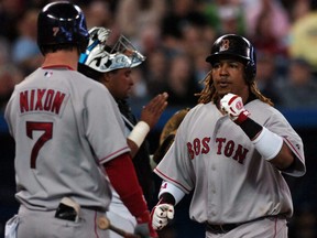 Manny Ramirez of the Boston Red Sox, right, receives congratulations from teammate Trot Nixon after a home run against the Toronto Blue Jays at the Rogers Centre April 21, 2006.
