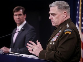 U.S. Joint Chiefs Chairman Army Gen. Mark Milley addresses a news conference as Defence Secretary Mark Esper listens at the Pentagon in Arlington, Virginia April 14, 2020.