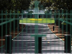 The gates are locked at the entrance of Magnolia Lane that leads to the clubhouse of Augusta National on March 30, 2020 in Augusta, Georgia. (Kevin C. Cox/Getty Images)