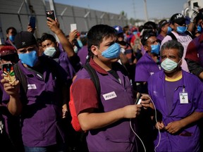 Employees of Regal, an assembly factory that manufactures electric motors, hold a protest to demand the respect to the quarantine to avoid contagion from the coronavirus in Ciudad Juarez, Mexico April 15, 2020. (REUTERS/Jose Luis Gonzalez)