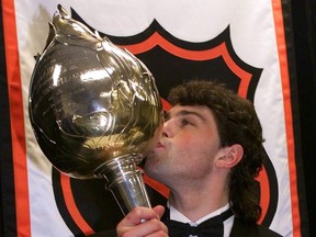 Jaromir Jagr, who could have been a Vancouver Canuck but wasn't drafted by the NHL team, kisses the Hart Memorial Trophy for the Most Valuable Player to his team (Pittsburgh Penguins) after winning it at the annual NHL awards on June 24, 1999.