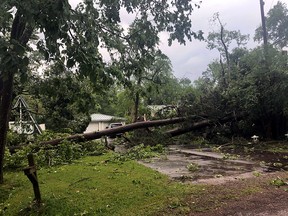 A fallen tree is seen near a house as the aftermath of the severe storms that killed few people in Oklahoma and Texas, Onalaska, Texas, April 22, 2020, in this picture obtained from social media.