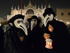 Masked revellers take part in the "Plague Doctors Procession" on Saint Mark Square in Venice on February 25, 2020.