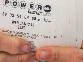 A person holds Powerball tickets in a file photo.