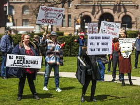 People gather at Queen's Park to protest against the COVID-19 shutdown, in Toronto, Ont. on Saturday, April 25, 2020.