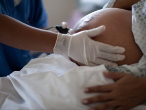 A pregnant woman is examined as she waits to give birth at a public hospital in Rio de Janeiro on Wednesday, July 25, 2012. (THE CANADIAN PRESS/AP, Felipe Dana)