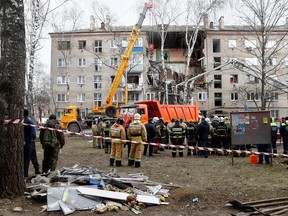 Members of the Russian Emergencies Ministry and investigators work near an apartment block, which partially collapsed after an apparent gas explosion, in the town of Orekhovo-Zuyevo near Moscow, Russia April 4, 2020.