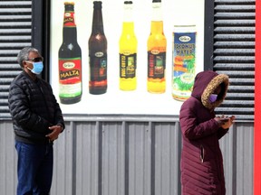 Social distancing is maintained in the line up to enter a grocery shop in Winnipeg on April 4, 2020. (Postmedia file photo)