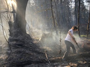 Toni Kerekes helps battle a wildfire in Squamish, B.C., Thursday, April 16, 2020. The BC Wildfire Service says crews are making good progress on a ground fire that's so far charred one square kilometre of bush and trees in the Upper Squamish Valley.