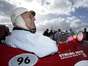 Former Formula One world champion Stirling Moss of Britain sits in a Maserati replica car during the Australian Grand Prix  in Melbourne in this April 2, 2006, file photo.